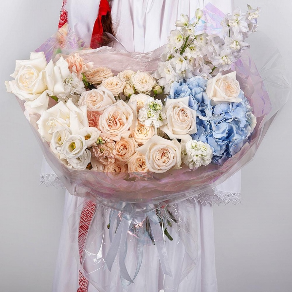 White rose 50 cm Ecuador - 2, Blue/purple hydrangea - 1, Spray peony rose  - 5, Carnation white, cream - 7, White Matthiola - 4, Baltica White Spray Chrysanthemum - 1, lisianthus - 1, Blue Delphinium, Wrapping Paper