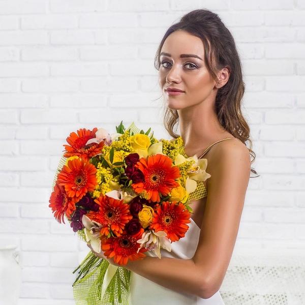 Gerbera daisies - 7, White Cymbidium Orchid Bud - 7, Spray rose: red 50 cm - 5, Yellow rose 50 cm - 5, Flask for orchids, Solidago (1 pc.), Pistachio, Mesh (Abaka), Ribbon