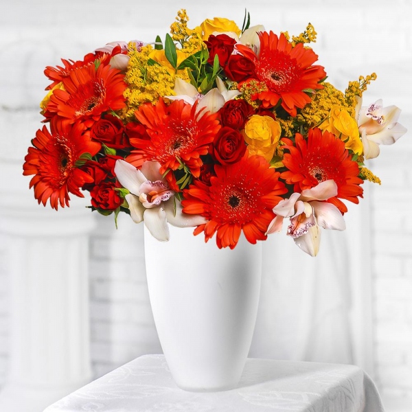 Gerbera daisies - 7, White Cymbidium Orchid Bud - 7, Spray rose: red 50 cm - 5, Yellow rose 50 cm - 5, Flask for orchids, Solidago (1 pc.), Pistachio, Mesh (Abaka), Ribbon