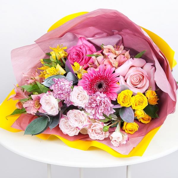 Gerbera pink - 3, Alstromeria white, soft pink - 2, Pink carnation - 3, Spray rose: yellow, orange 50 cm - 2, Pink rose 50 cm - 4, Alstromeria Yellow, Orange - 1, Spray rose: white, cream, light pink 50 cm - 1, Ruscus, Wrapping Paper