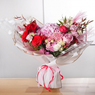 Red rose 50 cm - 4, Pink rose 50 cm - 2, Hydrangea - 1, Carnations - 3, Carnation spray - 3, Peony sprayrose - 2, Spray rose 50 cm (multiple small blooms on a stem) - 2, lisianthus - 4, Hypericum, Ruscus italian, Dried flowers in assortment, Wrapping Paper, Ribbon, Lace