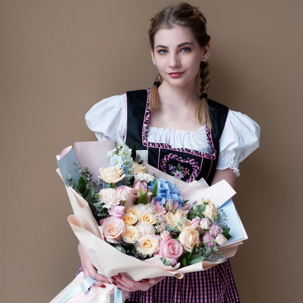 Blue/purple hydrangea - 1, Pink rose 50 cm - 4, Spray rose: white, cream, light pink 50 cm - 3, Rose Cream 50 cm - 5, Alstromeria white, soft pink - 4, Carnation white, cream - 7, Pink Lisianthus (Eustoma) - 2, Ozotamnus, Limonium (1 pc.), Blue Delphinium, Ruscus, Eucalyptus, Wrapping Paper