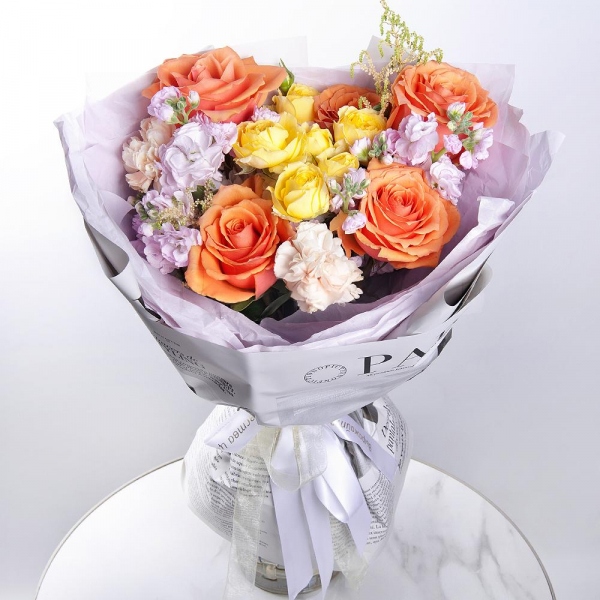 Rose Orange 50 cm Ecuador (High Magic, High Yollow Magic) - 7, Spray rose: yellow, orange 50 cm - 1, Baltica White Spray Chrysanthemum - 1, Carnation white, cream - 6, Matthiola Lilac - 2, Astilbe, Wrapping Paper