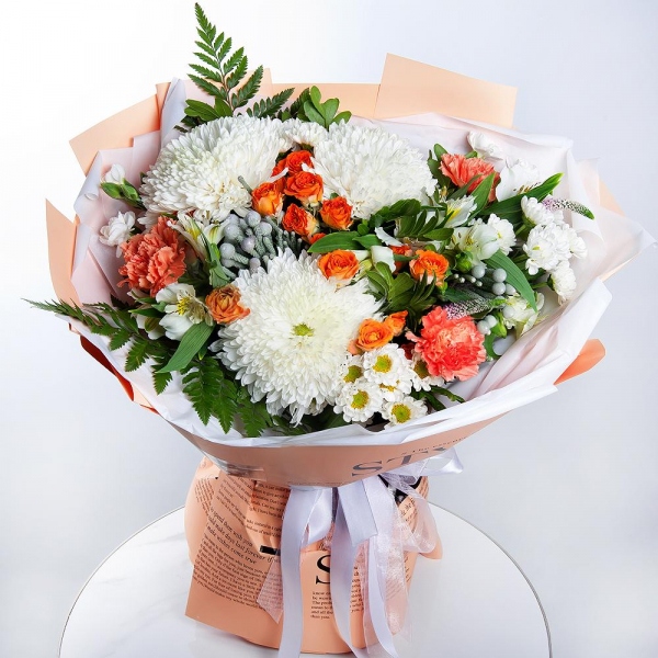 Magnum White Chrysanthemum - 3, Santini White Spray Chrysanthemum - 4, Spray rose: yellow, orange 50 cm - 3, Orange carnation - 7, White spray carnation - 7, Alstromeria white, soft pink - 7, Fern (1 pc.), Pistachio, Brunia Green Lanuginosa (1 pc.), Veronica spray, Wrapping Paper